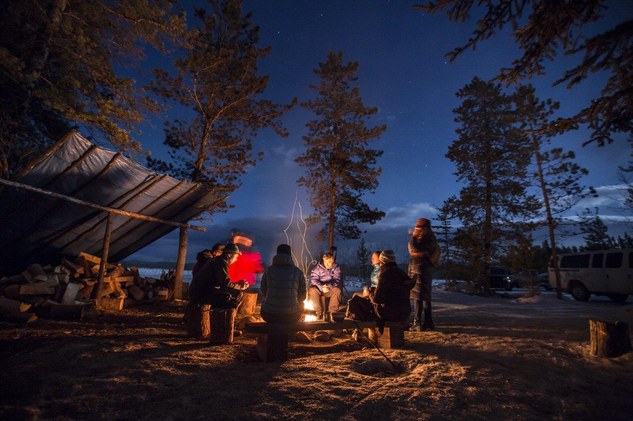 people spending the evening by the fire outside in Whitehorse