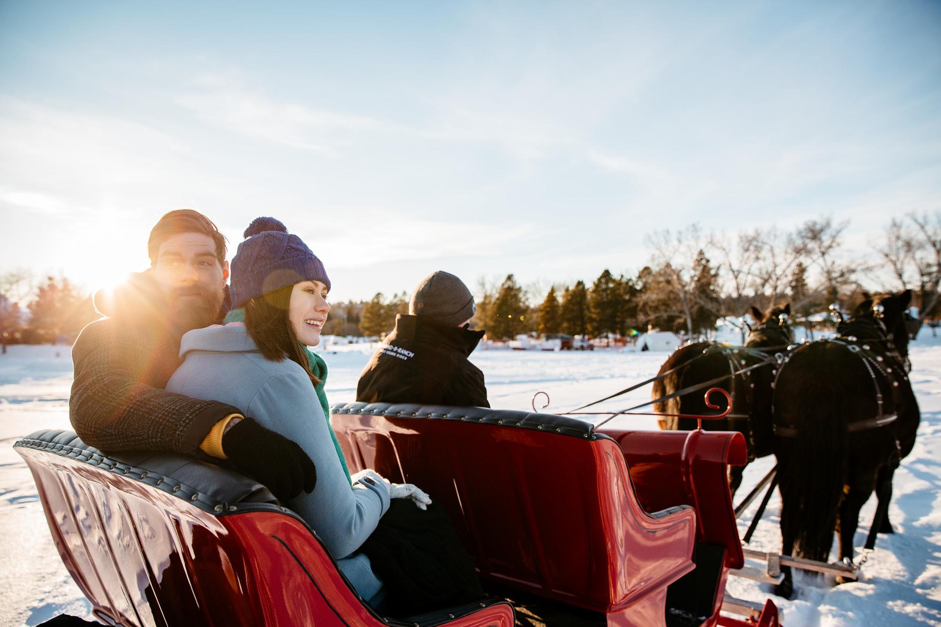 two people in a horse drawn sleigh riding around Hawrelak Park