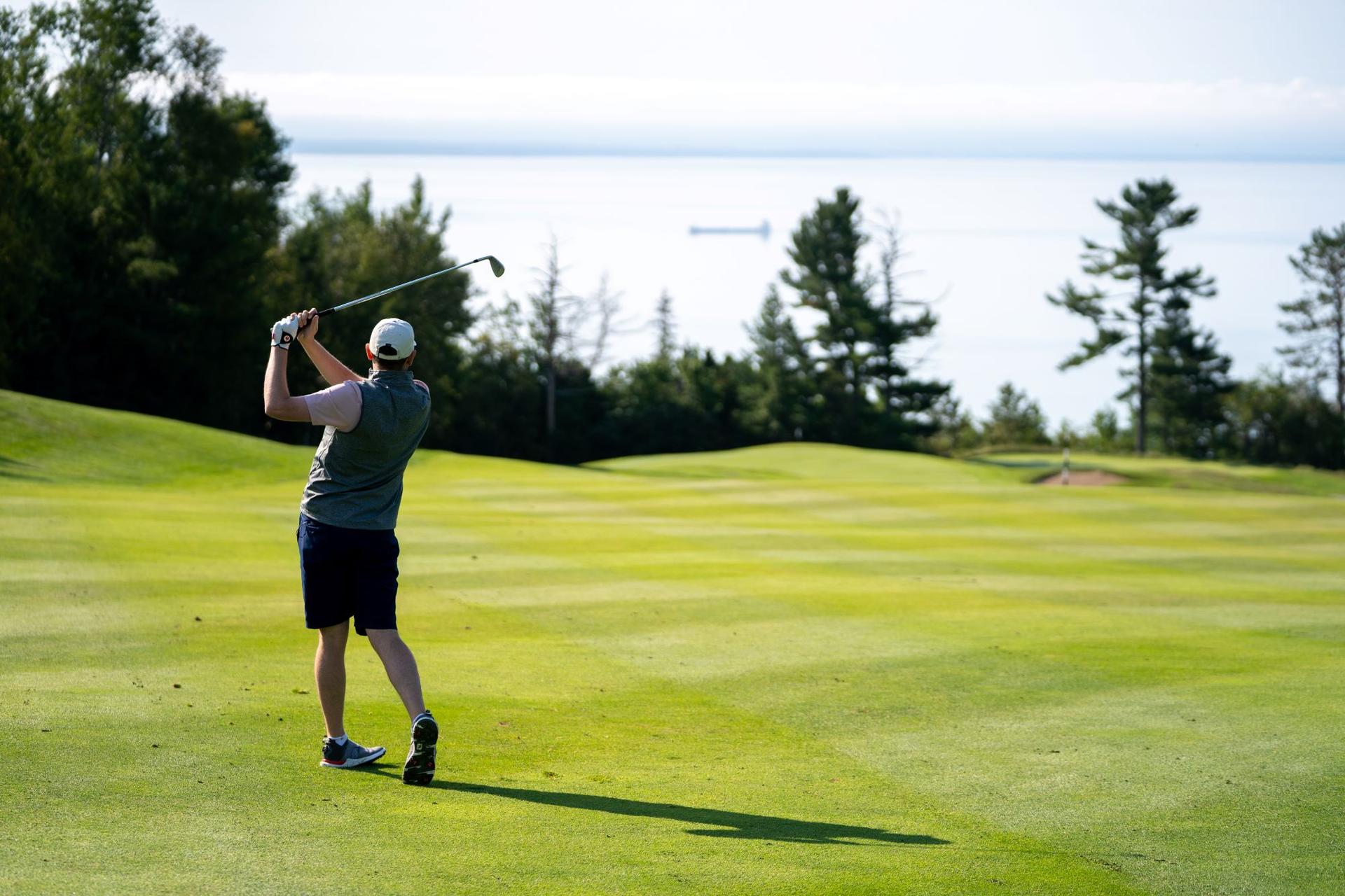 Host Adam Stanley hits his approach shot on the back nine of the Fairmont Le Manoir Richelieu