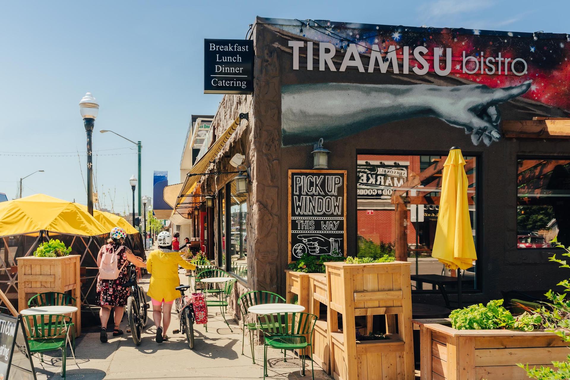 people on bikes by Tiramisu Bistro in edmonton