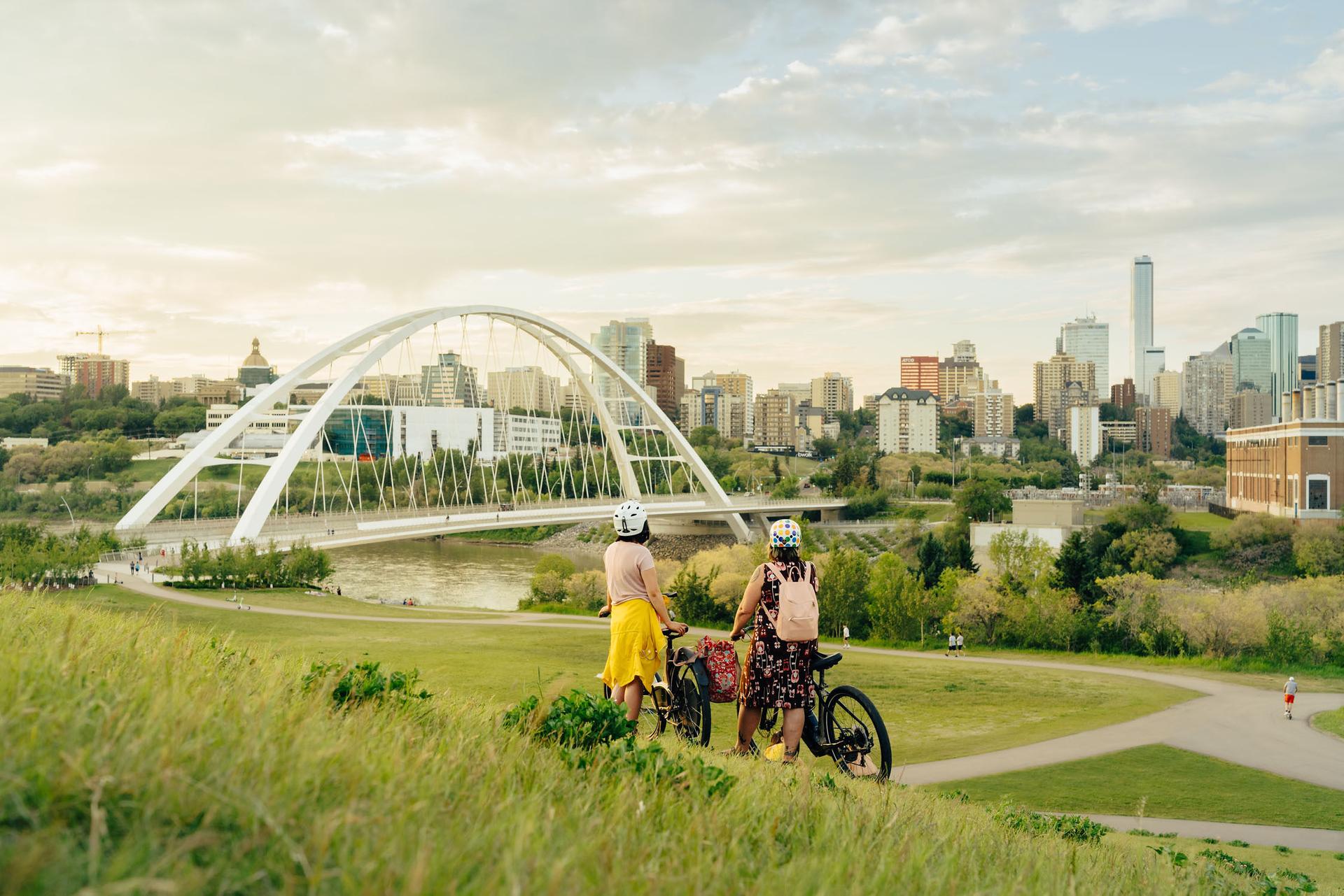 people with bikes looking at edmonton skyline
