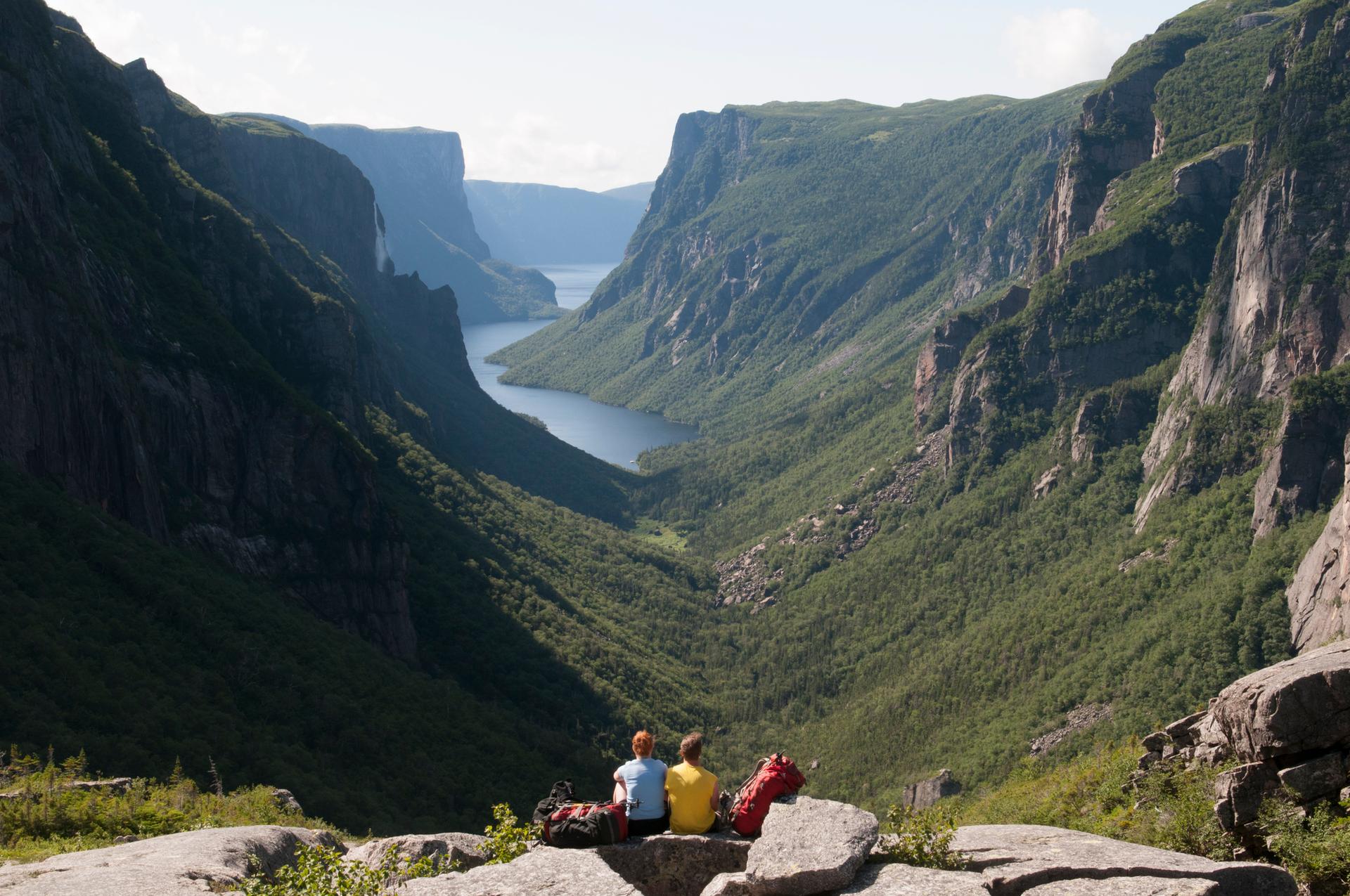 Hikers taking in the view at Gros Morne National Park, Western Brook Pond Fjord, Newfoundland and Labrador