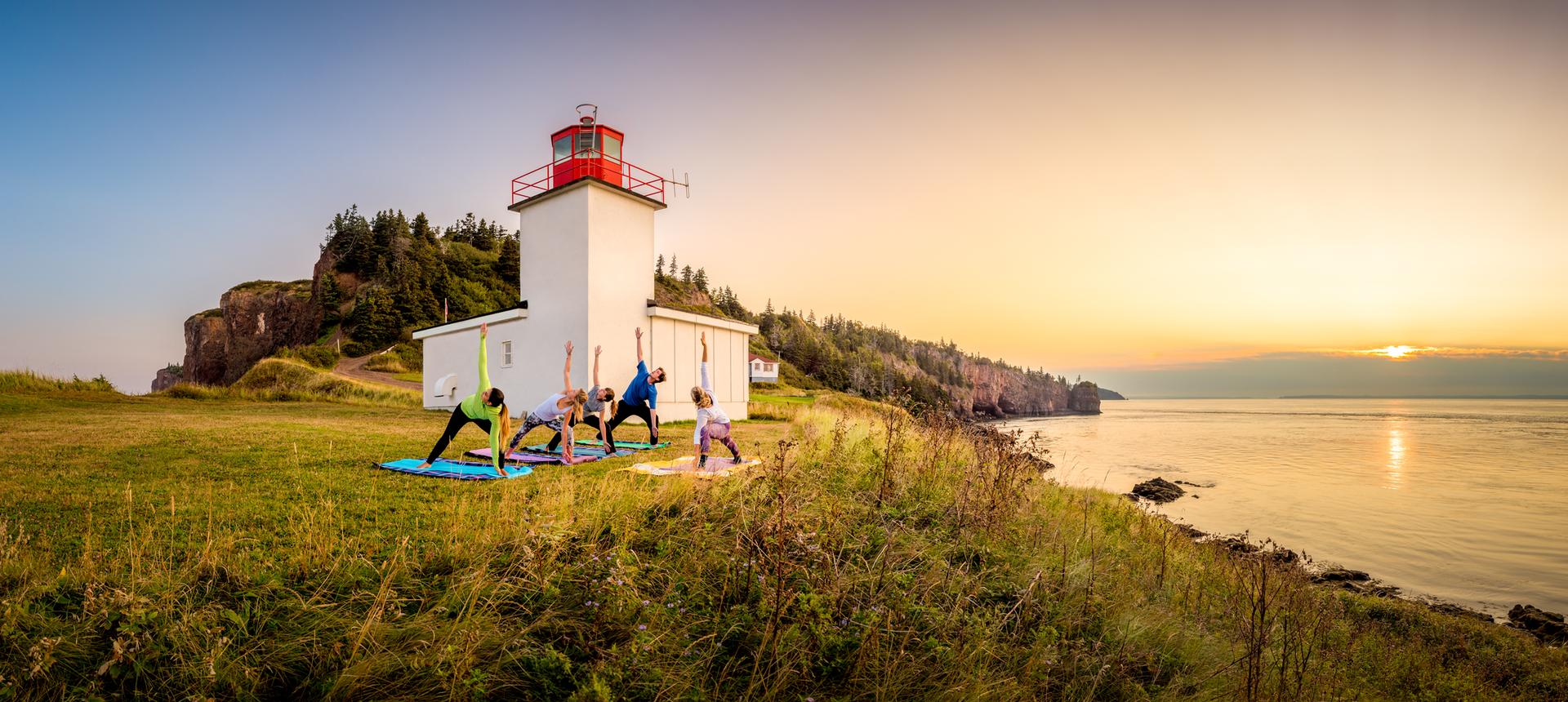 Cliff’s edge yoga session by the Cape d'Or lighthouse
