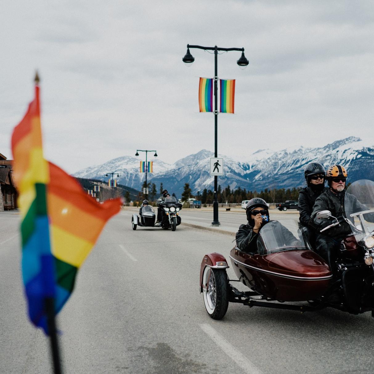 Motorcyclists celebrate pride with flags in Jasper