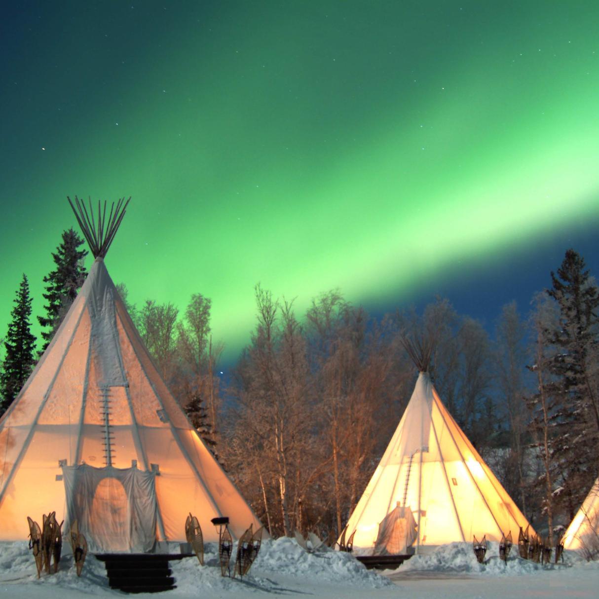 Aurora Village, three teepees under the northern lights, Yellowknife, Northwest Territories, Canada