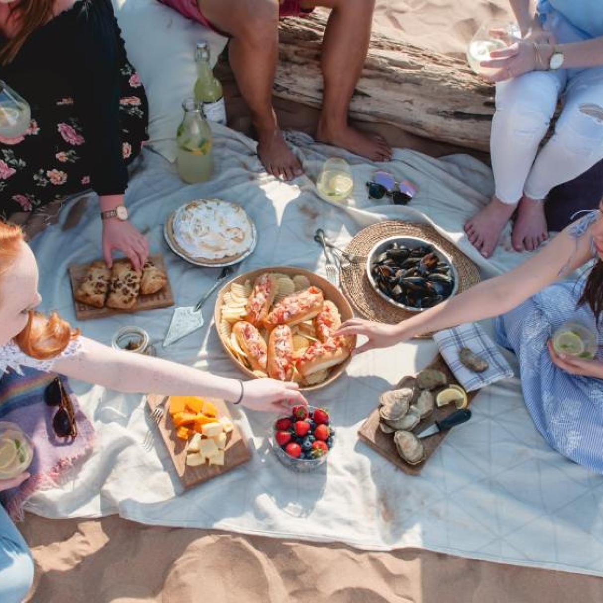 A group enjoying a picnic on the beach