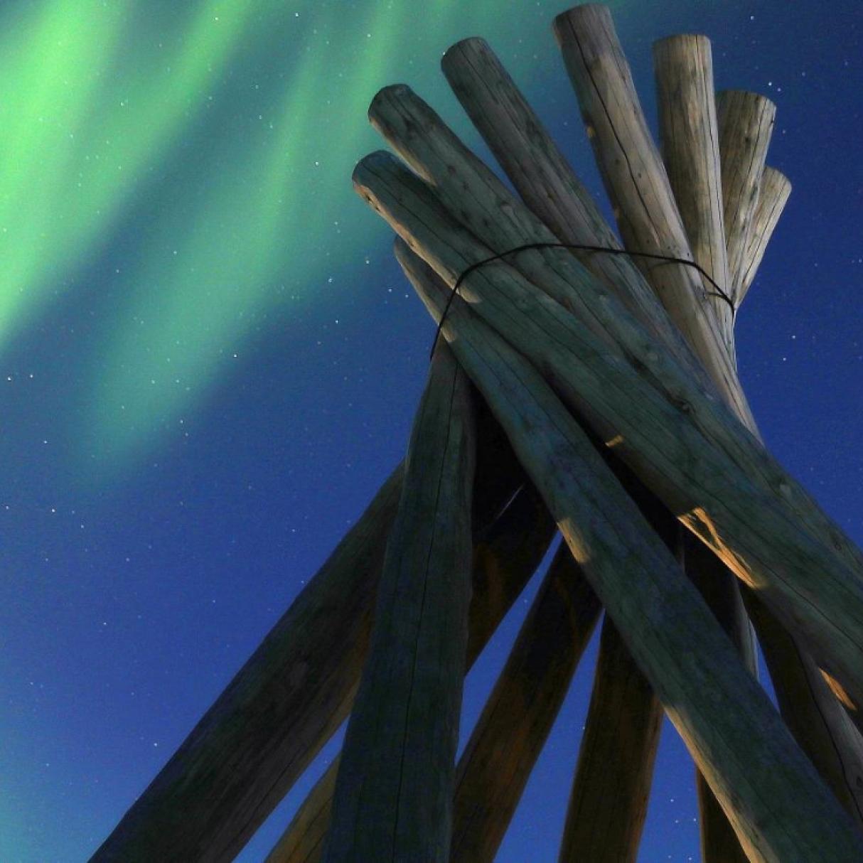 The northern lights over a wood structure