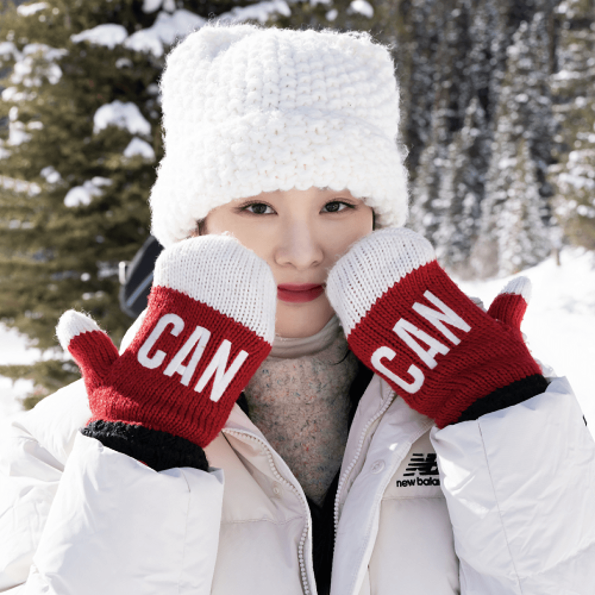 A tourist enjoying the snow holds up her Canada gloves