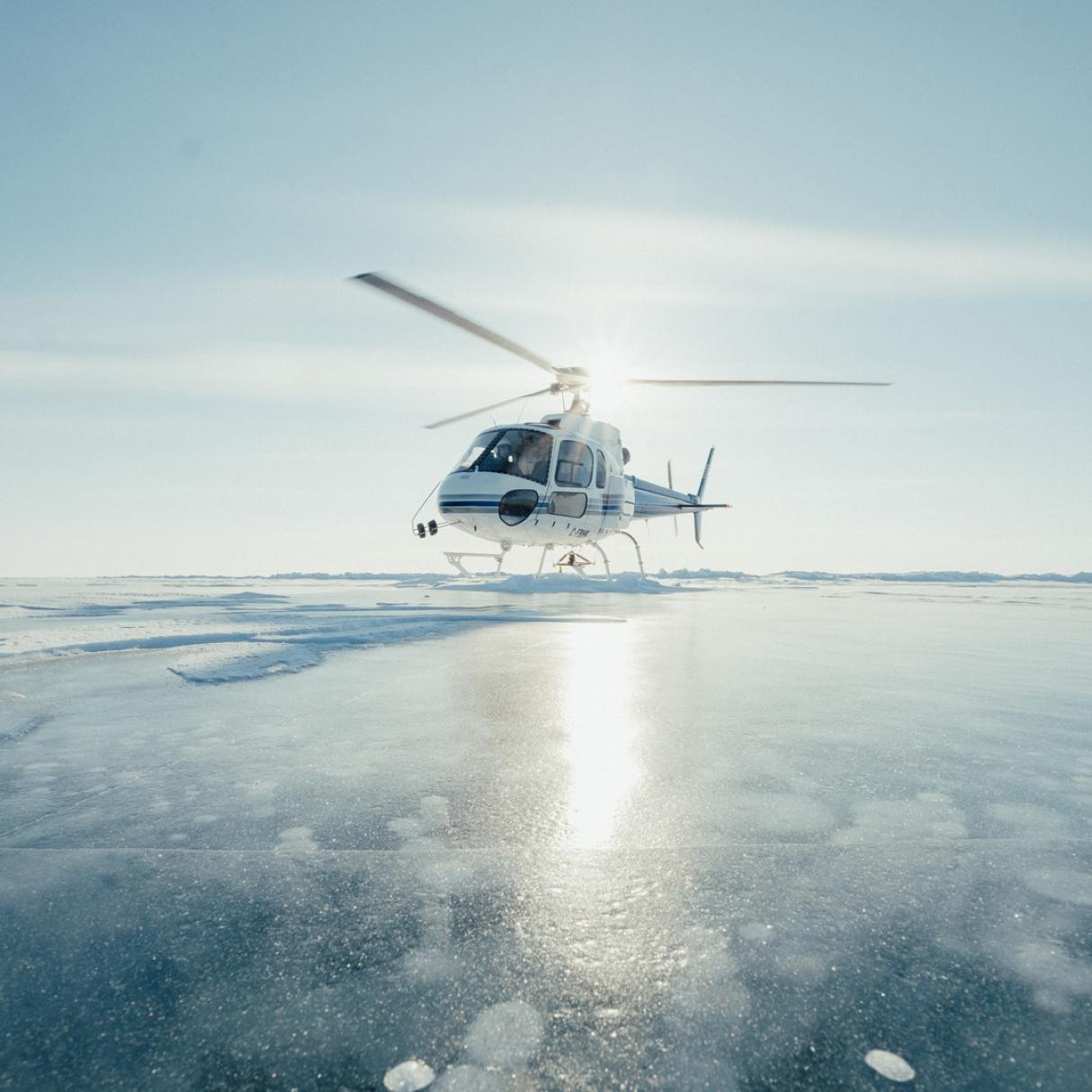 A helicopter stationed on an ice field