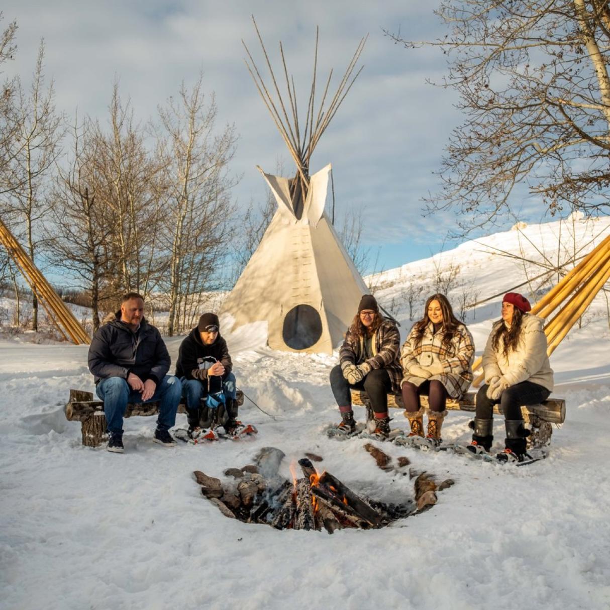 People gathered around a fire at Wanuskewin Heritage Park