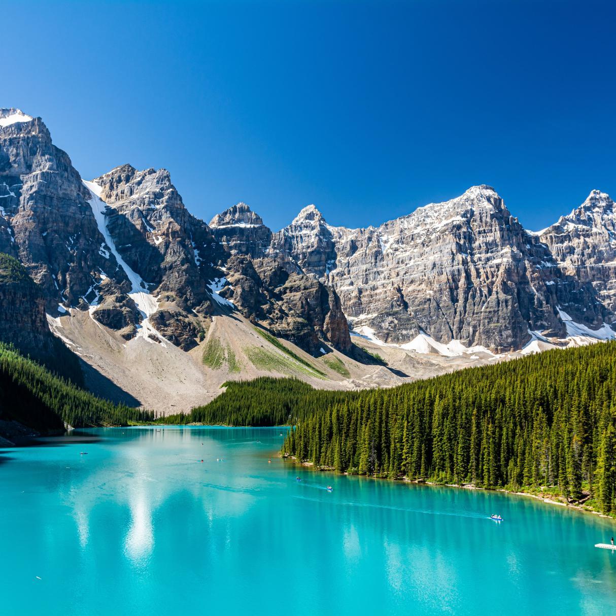Crystal blue lake with mountains above