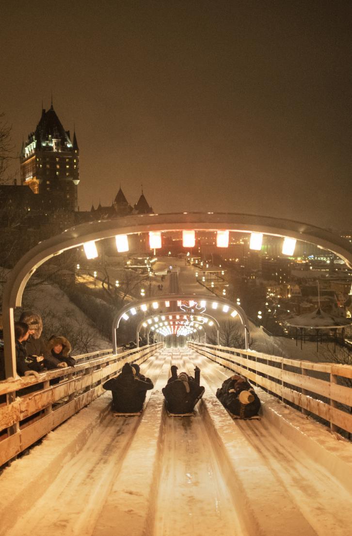 People sledding down the famous toboggan slide on the Dufferin Terrace in Old Québec