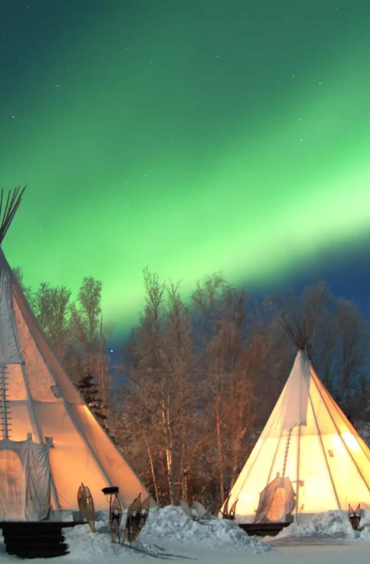 Tepees under the northern lights in Aurora Village in the Northwest Territories